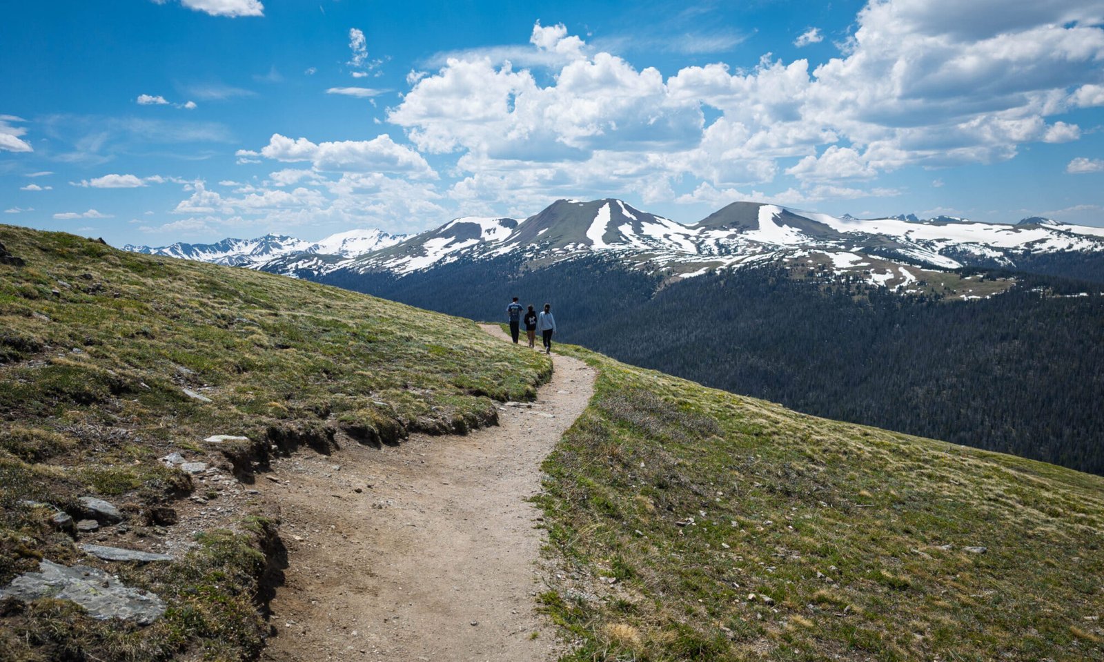 A family walking on a path in Rocky Mountain National Park